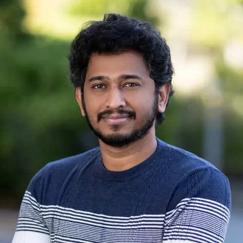 A man with a beard and a striped shirt.